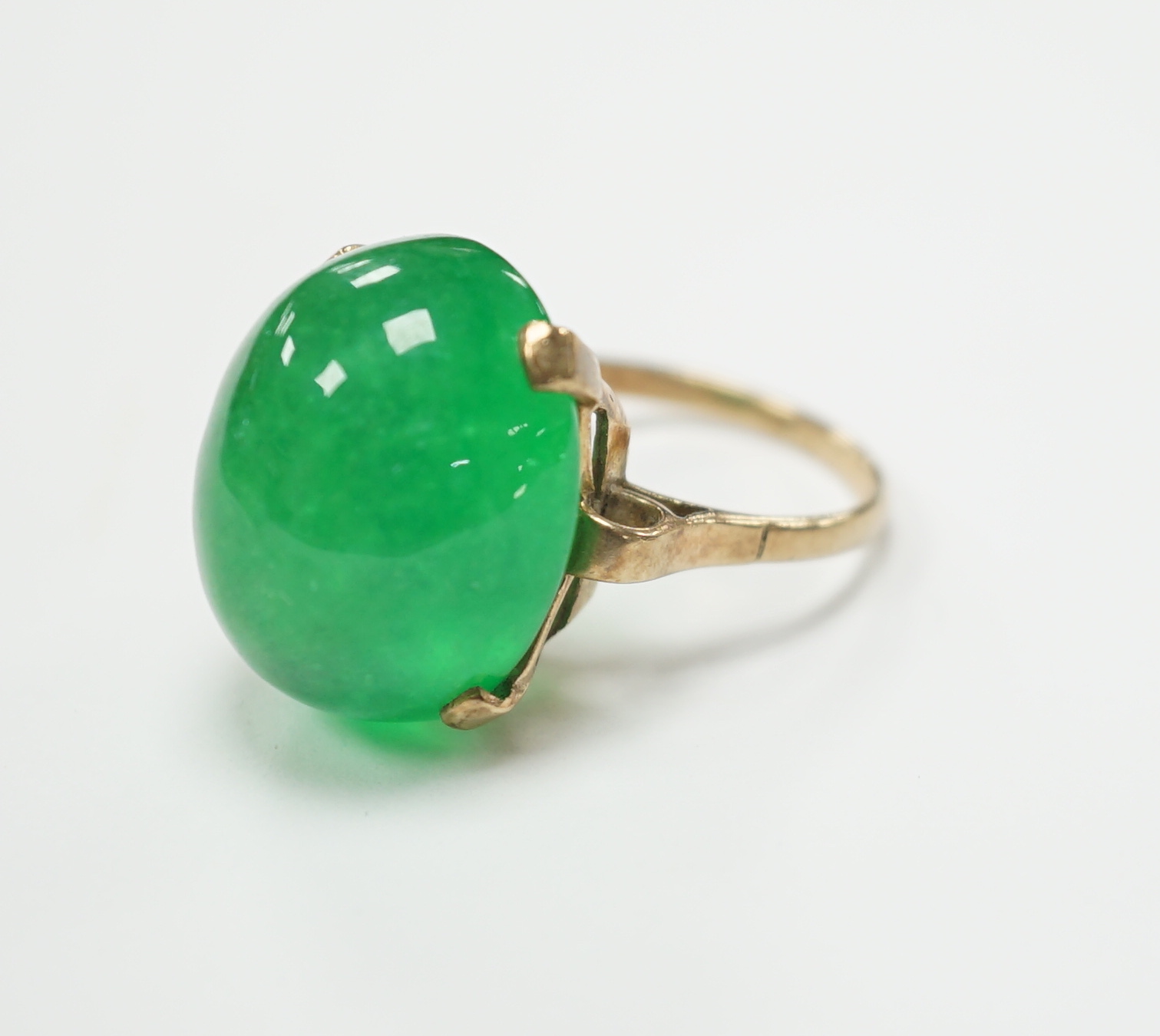 A 9ct and large cabochon oval jade set ring, size P/Q, gross weight 11.6 grams, the stone measuring approx. 21.1mm by 17.4mm, with a depth of 12.4mm.